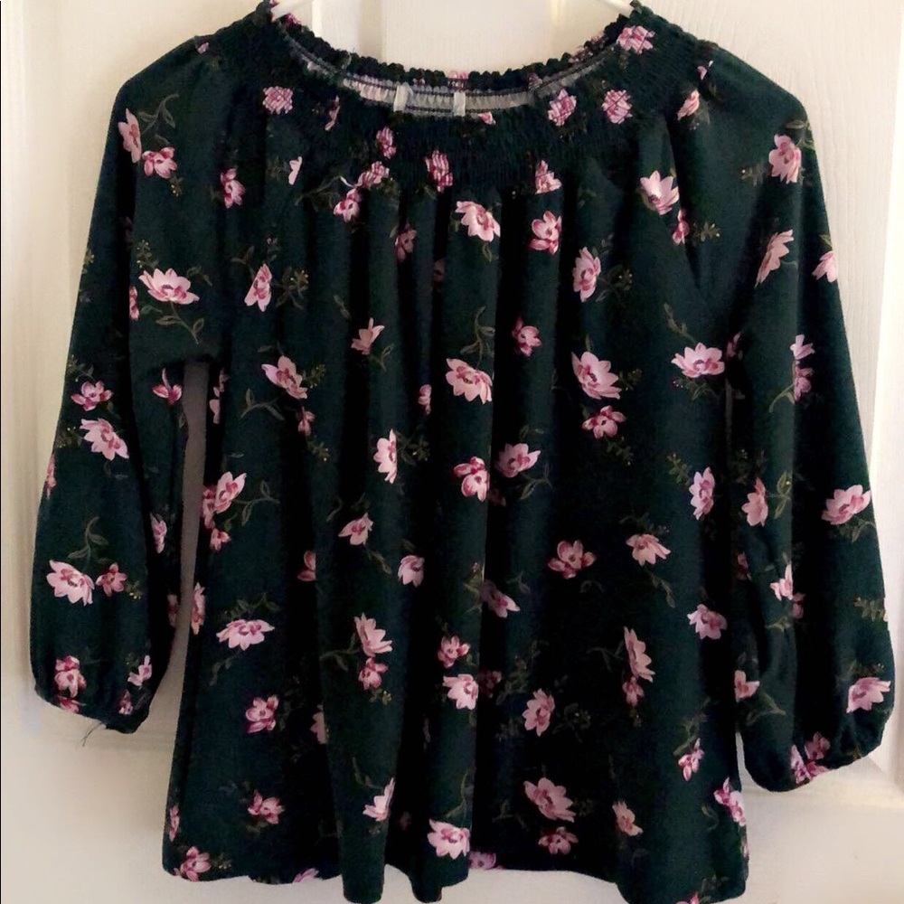 Green off the shoulder long sleeve shirt.